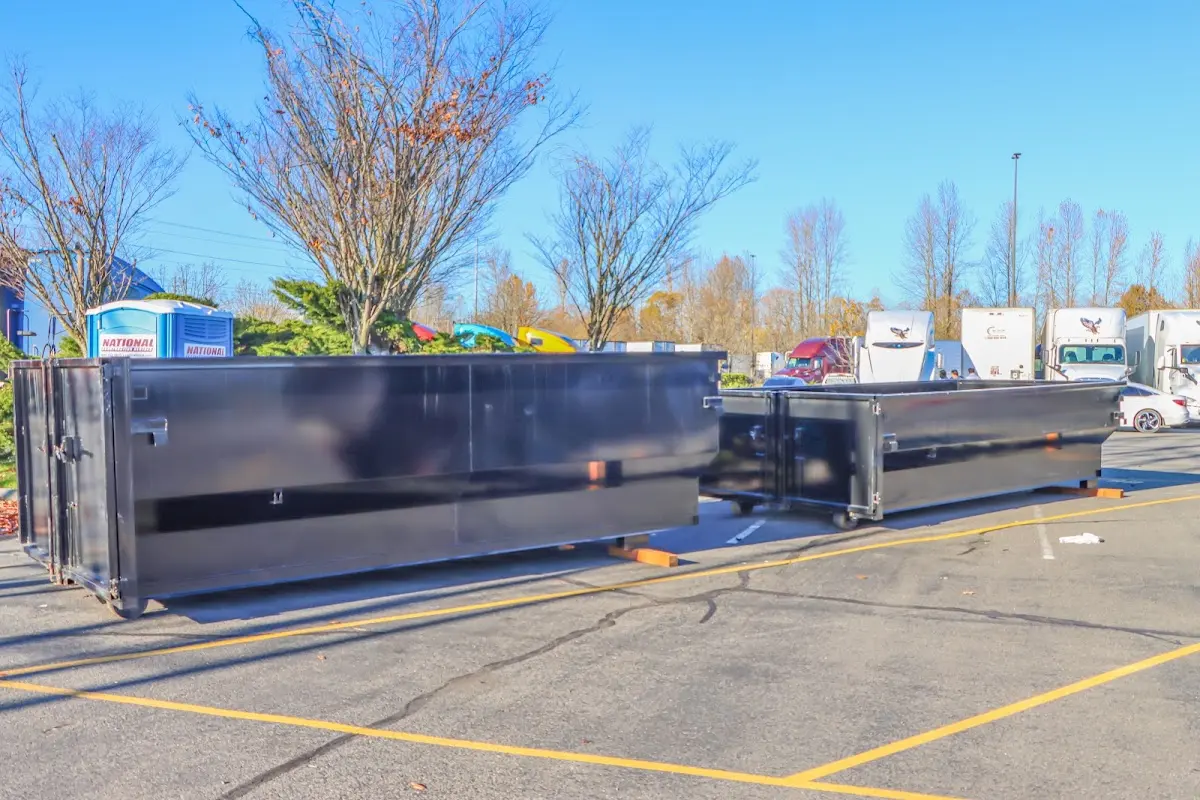 Professional dumpster rental service with roll-off container on residential driveway in Dock Junction